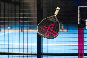 Ukraine Kyiv, April 02 2024. paddle tennis racket and balls on the blue paddle court photo