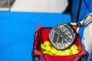 Ukraine Kyiv, April 02 2024. paddle tennis racket and balls on the blue paddle court photo