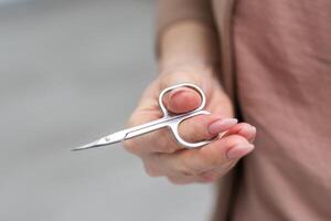 scissors in a hand on a white background photo