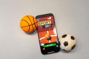 Sports betting website in a mobile phone screen, ball, money photo