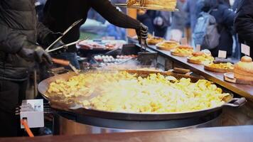 Close-up of Christmas market street food featuring rustic potatoes, burgers, and traditional Estonian dishes video