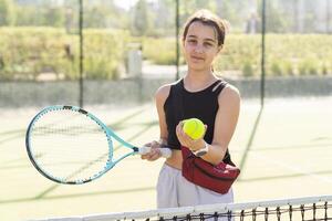 A person holding a racket on a court photo