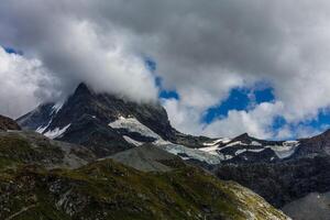 Panorama of cloud layer from mountain top over Swiss alps photo