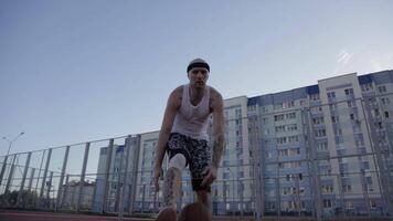 One guy play basketball at district sports ground. video
