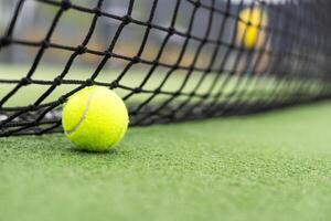 Tennis Ball on the Court against the Court Net photo