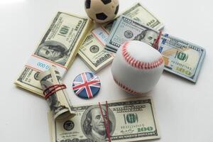 Small balls on heap of dollars isolated on a white background photo