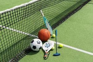 Set of sport equipment on green grass photo