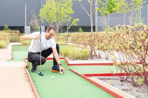 player looks at his hit on a mini golf course photo