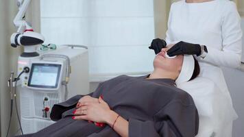 Cleaning facial skin before laser therapy at cosmetology clinic video