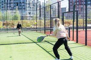 madre y hija jugando padel al aire libre foto