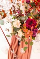 Festive table setting with basket of autumn flowers, candle photo