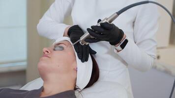 Using YAG laser for facial skin therapy at cosmetology clinic video