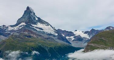 Mountain Panorama in the Swiss Alps, cloudy sky. photo