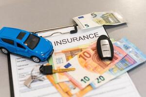 Car insurance form with model and policy document photo