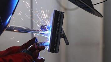 Industry welder man welding a metal parts in the factory, industrial concept video