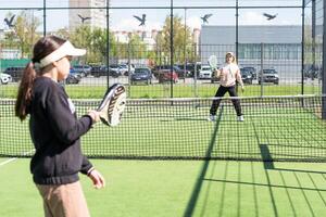 mother and daughter play padel photo