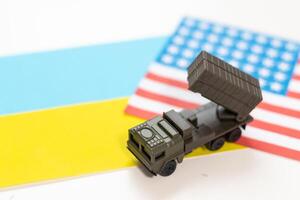 military vehicle and flags of the USA and Ukraine. Defeat of Russia in war in Ukraine concept photo