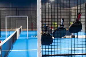 rackets and paddle balls on a court ready to play photo