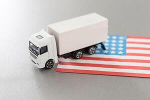 USA Logistics Concept. White Delivery Van on USA Flag background. 3d Rendering. photo