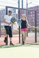 Ukraine Kyiv, April 02 2024. Padel training coach in a session, mentoring a female student, fostering skill development and a positive learning environment photo