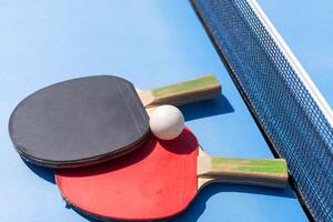 table tennis ball and paddle photo