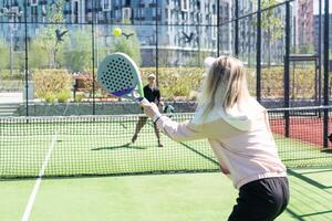 mother and daughter play padel photo