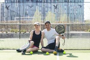 Ukraine Kyiv, April 02 2024. Padel training coach in a session, mentoring a female student, fostering skill development and a positive learning environment photo