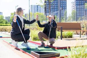 Mini-golf ball on artificial grass. Summer season game photo