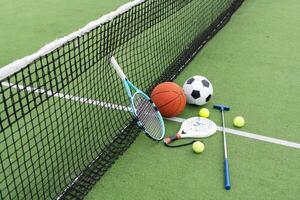 Set of sport equipment on green grass photo