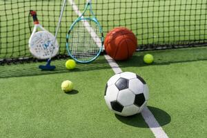 Set of sport equipment on green grass photo