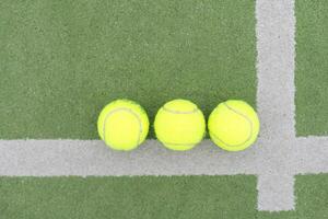 close up of a padel and tennis court with artificial grass and balls photo
