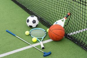 Set of sport equipment on green grass photo