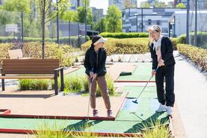 Mini-golf ball on artificial grass. Summer season game photo