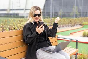 A businesswoman using a laptop on a golf course photo