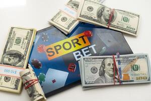 tablet pc with app for sport bets, on top of stacks of banknotes, white background, concept of online bets 3d render photo