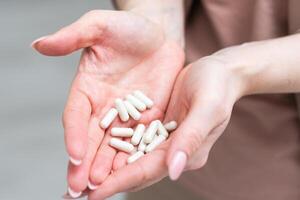 Medicine in hand on a white background photo