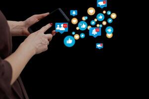 Close-up of smartphone in female hands. In foreground are virtual icons with picture of clouds, people and digital gadgets. Social media. Girl blogging, chatting online. Cloud technology. photo