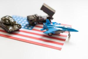 Miniature toy soldiers in battle scene with american flag background , Memorial Day concept photo