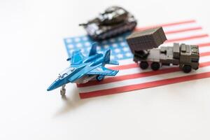 Miniature toy soldiers in battle scene with american flag background , Memorial Day concept photo