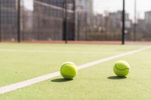 Bright greenish, yellow tennis ball on freshly painted court photo