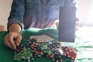 Women's hands shuffle cards. Concept of playing poker on the table with chips and cards. Gambling concept. Enjoying the moment photo