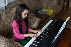 Portrait of little sad girl in ruined building. little settler plays the piano. Refugees photo