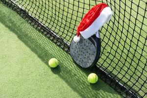 padel racket and santa hat photo