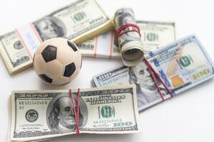 soccer ball over a lot of money. corruption football game. Betting and gambling concept. wold cup photo
