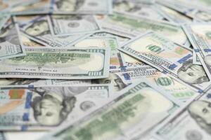 Very big amount of US hundred dollar bills close up. Huge quantity of united states currency notes on flat table photo