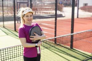 Portrait of attractive woman padel tennis player in outdoor court. photo