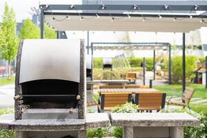 Closeup view of opened barbecue grill at outdoor patio photo