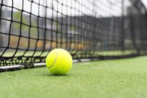 Tennis Ball on the Court against the Court Net photo