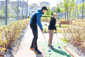 cute little girl on a miniature golf course. photo