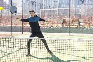 man playing paddle tennis at indoors pitch photo